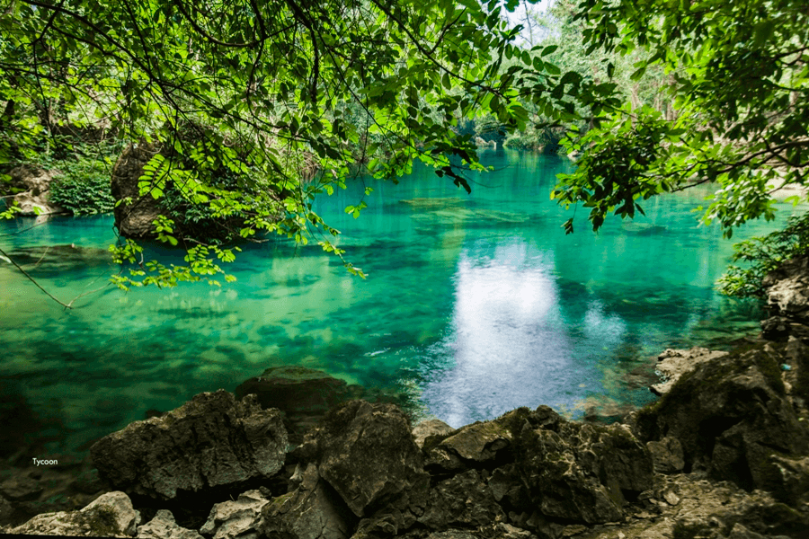 Lenin Stream with crystal-clear turquoise water in Pac Bo, Cao Bang
